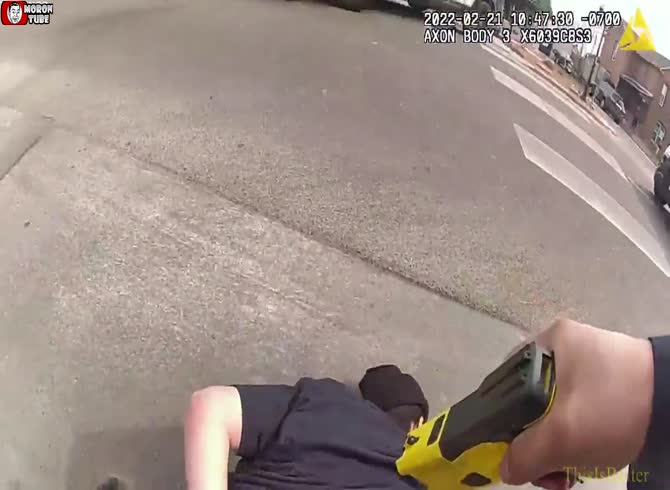 Video :As she lies on the ground, a police officer tases her